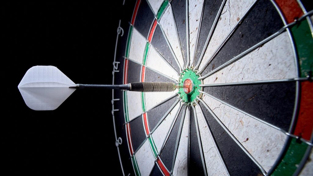 A single dart hit bullseye on dart board
